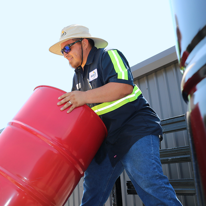 Man with diesel additive drum