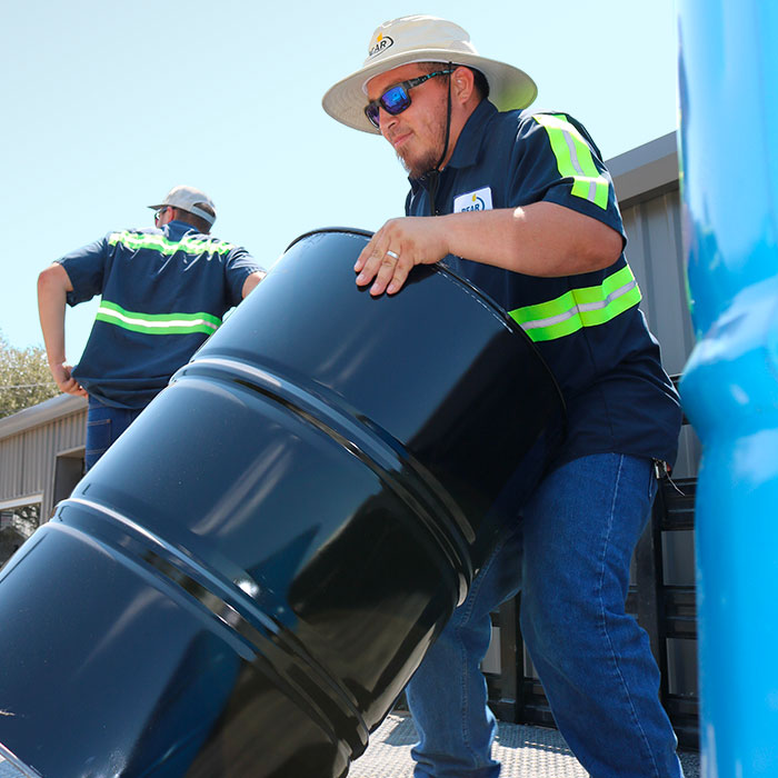 Bear Oil employee with a lubricant drum