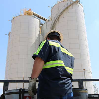 Bear Oil employee in front of pillars